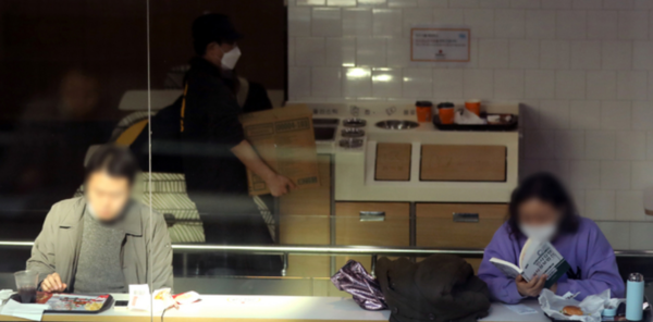 ▲ 한 패스트 푸드 점에 시민들이 앉아있다. 사진제공=뉴시스